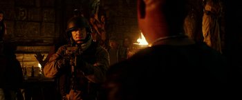 Movie still from “xXx: Return of Xander Cage” (2017), directed by D.J. Caruso – A group of men standing around a fire; Medium shot, Over the shoulder angle