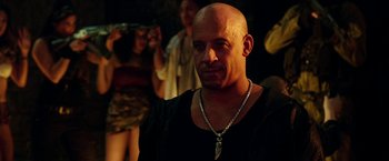 Movie still from “xXx: Return of Xander Cage” (2017), directed by D.J. Caruso – A man with a bald head wearing a necklace; Close Up shot, Over the shoulder angle