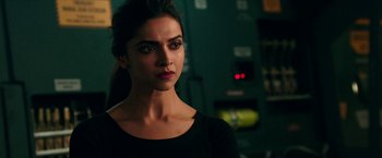 Movie still from “xXx: Return of Xander Cage” (2017), directed by D.J. Caruso – Deepika padukone in a black shirt looking at the camera; Close Up shot, Over the shoulder angle