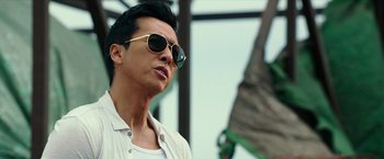 Movie still from “xXx: Return of Xander Cage” (2017), directed by D.J. Caruso – A person wearing sunglasses and a white shirt; Close Up shot, Low angle