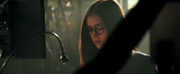 Movie still from “xXx: Return of Xander Cage” (2017), directed by D.J. Caruso – A woman wearing glasses looking down at her phone; Close Up shot, High angle