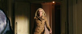 Movie still from “xXx: Return of Xander Cage” (2017), directed by D.J. Caruso – A woman in a brown coat is walking in a room; Medium shot, Low angle