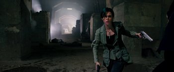 Movie still from “xXx: Return of Xander Cage” (2017), directed by D.J. Caruso – A woman holding a gun while standing in an abandoned building; Medium shot, High angle