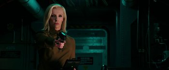 Movie still from “xXx: Return of Xander Cage” (2017), directed by D.J. Caruso – A woman holding a gun while standing in a room; Medium shot, Over the shoulder angle