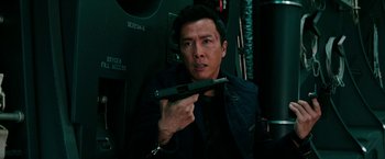 Movie still from “xXx: Return of Xander Cage” (2017), directed by D.J. Caruso – A man holding a gun while wearing a black jacket; Close Up shot, High angle