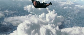 Movie still from “xXx: Return of Xander Cage” (2017), directed by D.J. Caruso – A man in a black suit parachuting in the sky; Wide shot, Overhead angle