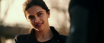 Movie still from “xXx: Return of Xander Cage” (2017), directed by D.J. Caruso – A person smiling for the camera; Close Up shot, Over the shoulder angle