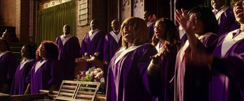 Movie still from “xXx: Return of Xander Cage” (2017), directed by D.J. Caruso – A group of people in purple robes singing; Medium shot, Low angle