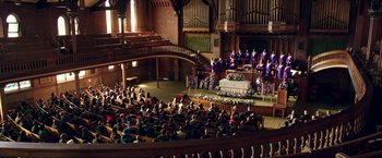 Movie still from “xXx: Return of Xander Cage” (2017), directed by D.J. Caruso – A large group of people sitting in front of an organ; Extreme Wide shot, High angle