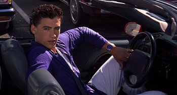 Movie still from “10 Things I Hate About You” (1999), directed by Gil Junger – A man sitting in the driver's seat of a car; Medium shot, High angle