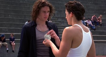 Movie still from “10 Things I Hate About You” (1999), directed by Gil Junger – A man and a woman standing next to each other; Medium shot, Over the shoulder angle