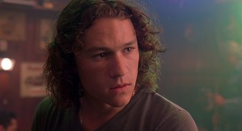Movie still from “10 Things I Hate About You” (1999), directed by Gil Junger – A person with long curly hair; Close Up shot, Low angle