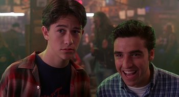 Movie still from “10 Things I Hate About You” (1999), directed by Gil Junger – Two young men posing for a picture at a party; Close Up shot, Low angle