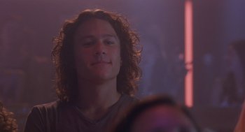 Movie still from “10 Things I Hate About You” (1999), directed by Gil Junger – A man with long curly hair is looking at the camera; Close Up shot, Low angle