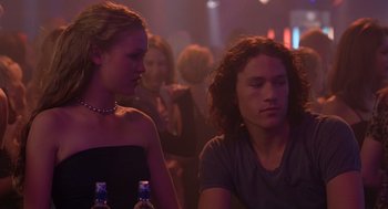 Movie still from “10 Things I Hate About You” (1999), directed by Gil Junger – A man and a woman sitting at a table; Medium shot, Over the shoulder angle