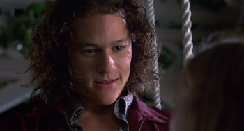 Movie still from “10 Things I Hate About You” (1999), directed by Gil Junger – A person with curly brown hair; Close Up shot, Over the shoulder angle