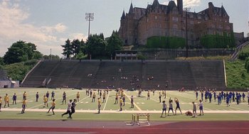 Movie still from “10 Things I Hate About You” (1999), directed by Gil Junger – A group of people are playing football on a field; Extreme Wide shot, High angle