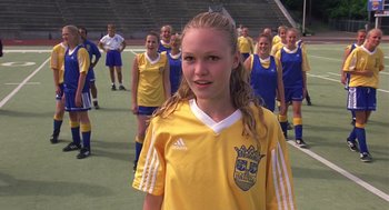 Movie still from “10 Things I Hate About You” (1999), directed by Gil Junger – A group of young women in yellow and blue soccer uniforms; Medium shot, High angle