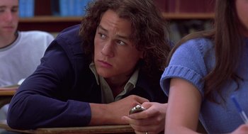 Movie still from “10 Things I Hate About You” (1999), directed by Gil Junger – A man with long brown hair holding a cell phone; Close Up shot, High angle