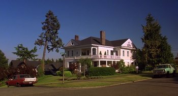 Movie still from “10 Things I Hate About You” (1999), directed by Gil Junger – A large white two - story house sitting next to a tree; Extreme Wide shot, High angle