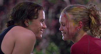 Movie still from “10 Things I Hate About You” (1999), directed by Gil Junger – Two young people with paint on their faces; Medium shot, Low angle