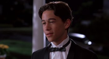 Movie still from “10 Things I Hate About You” (1999), directed by Gil Junger – A young man in a suit and bow tie; Close Up shot, High angle