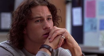 Movie still from “10 Things I Hate About You” (1999), directed by Gil Junger – A person with a hand on his chin; Close Up shot, Over the shoulder angle