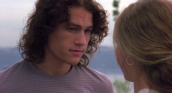 Movie still from “10 Things I Hate About You” (1999), directed by Gil Junger – A man with long hair and a woman with blonde hair; Close Up shot, Over the shoulder angle