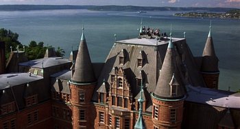 Movie still from “10 Things I Hate About You” (1999), directed by Gil Junger – An aerial view of a large building with a lake in the background; Extreme Wide shot, High angle