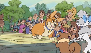 Movie still from “101 Dalmatians 2: Patch's London Adventure” (2002), directed by Brian Smith – A crowd of people are watching a cartoon dog; Wide shot, Over the shoulder angle