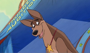 Movie still from “101 Dalmatians 2: Patch's London Adventure” (2002), directed by Brian Smith – A cartoon dog with a star on its collar; Medium shot, Low angle