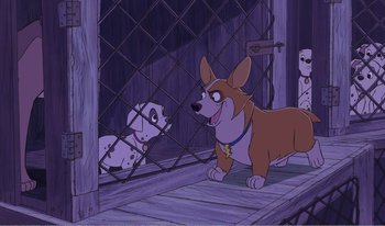 Movie still from “101 Dalmatians 2: Patch's London Adventure” (2002), directed by Brian Smith – A dog and a dalmatian are in a fenced in area; Wide shot, Over the shoulder angle
