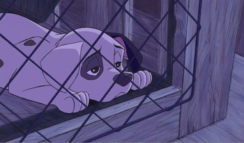 Movie still from “101 Dalmatians 2: Patch's London Adventure” (2002), directed by Brian Smith – A purple dog laying on the ground behind a fence; Close Up shot, High angle