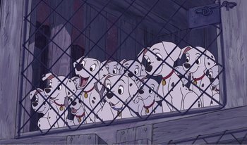 Movie still from “101 Dalmatians 2: Patch's London Adventure” (2002), directed by Brian Smith – A bunch of dogs that are sitting in a cage; Wide shot, High angle