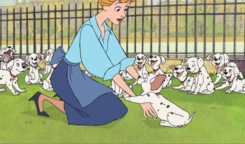 Movie still from “101 Dalmatians 2: Patch's London Adventure” (2002), directed by Brian Smith – A woman kneeling down next to a group of dogs; Wide shot, High angle