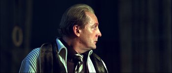 Movie still from “12” (2007), directed by Nikita Mikhalkov – An older man wearing a suit and a tie; Close Up shot, Low angle