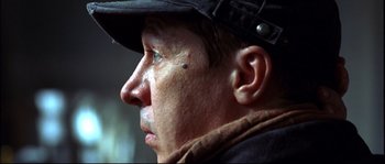 Movie still from “12” (2007), directed by Nikita Mikhalkov – A person wearing a hat; Close Up shot, Low angle