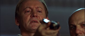 Movie still from “12” (2007), directed by Nikita Mikhalkov – A person holding a cell phone; Close Up shot, Low angle