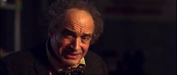 Movie still from “12” (2007), directed by Nikita Mikhalkov – An older man with curly hair and a beard; Close Up shot, Low angle
