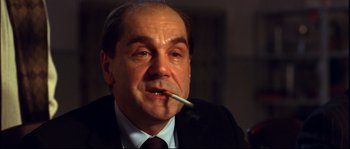 Movie still from “12” (2007), directed by Nikita Mikhalkov – A person smoking a cigarette; Close Up shot, Low angle