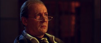Movie still from “12” (2007), directed by Nikita Mikhalkov – An older man wearing glasses and wearing a tie; Close Up shot, Low angle