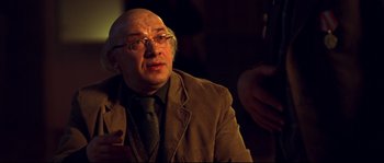 Movie still from “12” (2007), directed by Nikita Mikhalkov – An older man wearing a suit and tie; Close Up shot, Over the shoulder angle