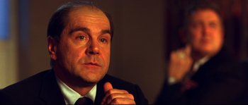 Movie still from “12” (2007), directed by Nikita Mikhalkov – A person wearing a suit and tie; Close Up shot, Over the shoulder angle