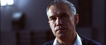 Movie still from “12” (2007), directed by Nikita Mikhalkov – An older man is looking at the camera; Close Up shot, Low angle