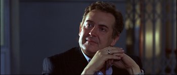 Movie still from “12” (2007), directed by Nikita Mikhalkov – A person wearing a suit and tie; Close Up shot, Low angle