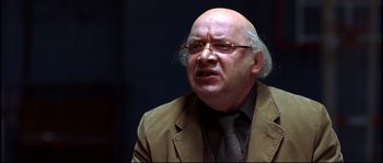 Movie still from “12” (2007), directed by Nikita Mikhalkov – An older man wearing a suit and tie; Close Up shot, Over the shoulder angle