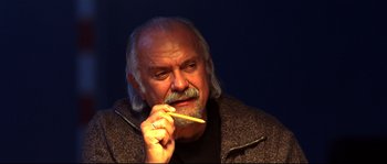 Movie still from “12” (2007), directed by Nikita Mikhalkov – An older man holding a pencil in his mouth; Close Up shot, Low angle