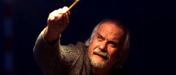 Movie still from “12” (2007), directed by Nikita Mikhalkov – An older man is holding a wooden stick; Close Up shot, Low angle
