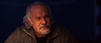 Movie still from “12” (2007), directed by Nikita Mikhalkov – An older man with a beard is looking into the distance; Close Up shot, Low angle