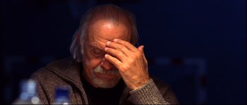 Movie still from “12” (2007), directed by Nikita Mikhalkov – An older man holding his hand up to his face; Close Up shot, Low angle